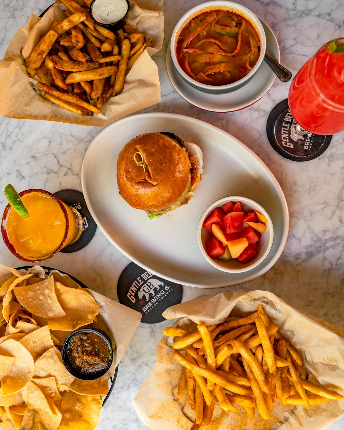 A burger with fries and a cocktail at Gentle Ben's